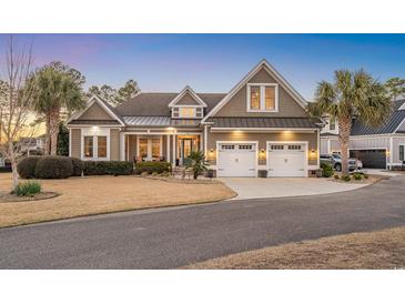 Beautifully landscaped two-story home featuring a two-car garage and inviting front porch at 587 Starlit Way, Myrtle Beach, SC 29579