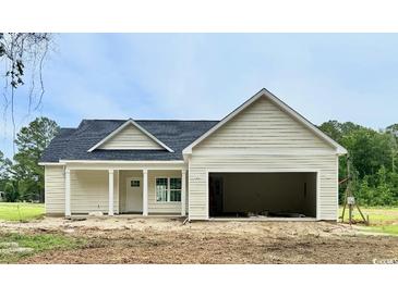 Charming single-story home with a covered porch, garage and light siding at 6049 Hodges Rd., Conway, SC 29527