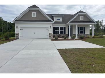 Charming single-Gathering home with a two-car garage and neutral exterior paint scheme at 7059 Shady Grove Rd., Conway, SC 29527