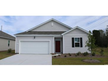 Charming single-story home with a two-car garage, red door, and tidy landscaping at 8054 Bear Claw Ct., Conway, SC 29526