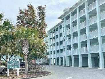 Exterior view of the Summerhouse featuring multiple floors with individual balconies and landscaped grounds at 14290 Ocean Highway # 207, Pawleys Island, SC 29585