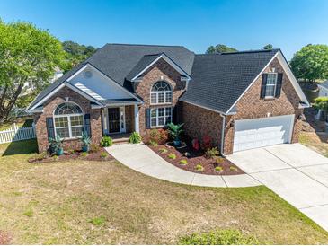 Aerial view of the brick home highlighting the well-maintained lawn, and a large driveway at 227 Old Hickory Dr., Conway, SC 29526