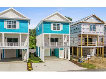Beautiful blue and white raised beach home with large driveway and covered parking at 2306 Seaseeker Ln., Myrtle Beach, SC 29577