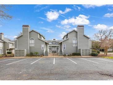 Charming exterior view of a two-story condo showcasing its architectural details and inviting facade at 311 Cumberland Terrace Dr. # 7-E, Myrtle Beach, SC 29572