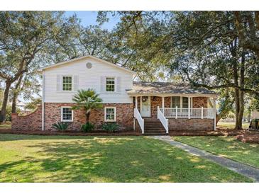 Charming two-story home featuring a brick foundation and a welcoming front porch at 315 Oak Dr. N, Surfside Beach, SC 29575