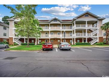 Spacious condo building with private balconies and well-maintained landscaping and ample parking at 5750 Oyster Catcher Dr. # 522, North Myrtle Beach, SC 29582