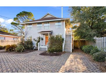 Charming two-story home with a brick driveway and welcoming front porch at 607 18Th Ave. S, North Myrtle Beach, SC 29582