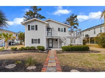 Charming exterior of home featuring a landscaped yard and inviting entryway with classic design elements at 609 23Rd Ave. N, North Myrtle Beach, SC 29582