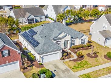 Charming single-story home featuring solar panels and a well-manicured lawn at 726 Carolina Farms Blvd., Myrtle Beach, SC 29579