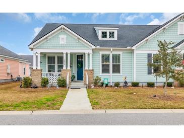 Charming cottage-style home with light blue shake siding and inviting front porch at 1016 Longwood Bluffs Circle, Murrells Inlet, SC 29576