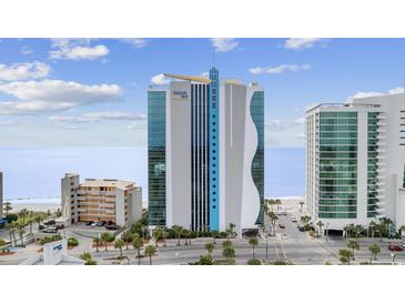 Modern high-rise condo building with ocean views, blue sky and white clouds at 107 S Ocean Blvd. # 602, Myrtle Beach, SC 29577