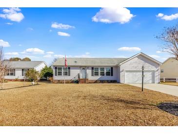 Charming single-story home with a well-manicured lawn, a two-car garage, and traditional architectural details at 109 Deer Tree Dr., Murrells Inlet, SC 29576