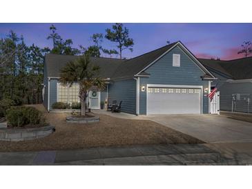 Charming home with a two car garage, blue siding, manicured lawn, and a beautiful palm tree in the front yard at 1118 Prescott Circle, Myrtle Beach, SC 29577