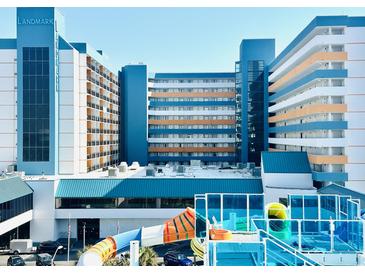 Bright and cheerful resort with a colorful waterslide and blue-accented architecture against a clear sky at 1501 S Ocean Blvd. # 841, Myrtle Beach, SC 29577