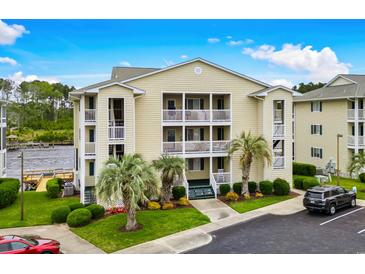 Inviting condo complex with a beautiful lawn, mature trees, and convenient parking at 218 Landing Rd. # G, North Myrtle Beach, SC 29582