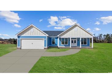 Charming single-story home with blue siding, white trim, a two-car garage, and a welcoming front porch at 3372 Gurley Rd., Loris, SC 29569