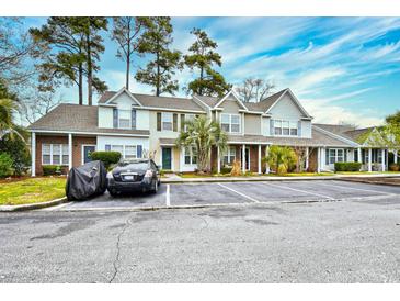 Charming townhomes with ample parking, brick accents, and mature trees, offering a welcoming curb appeal at 3506 Evergreen Way # 3506, Myrtle Beach, SC 29577