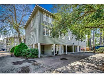 Inviting exterior view of raised beach home featuring ample parking and charming architectural details at 5137 Highway 17 Business # 3A, Murrells Inlet, SC 29576