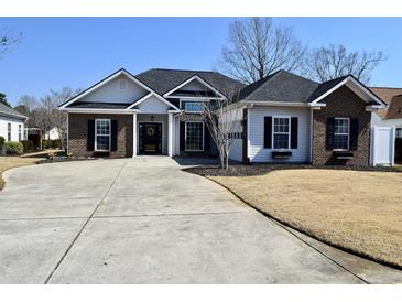 Charming single-story home boasts a well-manicured lawn, brick and vinyl siding, and a spacious driveway at 517 Brooksher Dr., Myrtle Beach, SC 29588