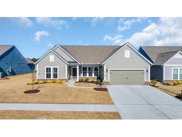 Charming single-story home with a well-manicured lawn, neutral siding, and attached two-car garage at 7322 Sarteano Dr., Myrtle Beach, SC 29572