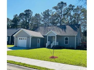 Charming single story home featuring a manicured lawn and attached garage on a sunny day at 1000 Weldon Ln., Conway, SC 29526