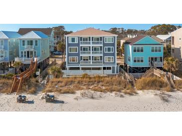 Beautifully landscaped beachside home with multiple balconies and easy access to the sandy shore at 1417 S Ocean Blvd. # 202, Surfside Beach, SC 29575