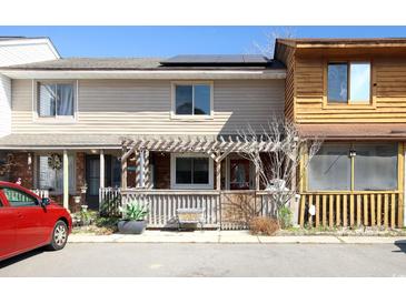 Charming townhouse showcasing a covered front porch and solar panels on the roof at 1424 Glenns Bay Rd. # 1424, Myrtle Beach, SC 29575