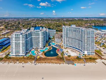 Stunning aerial view of beachfront condos with multiple pools and water features at 158 Seawatch Dr. # 1112, Myrtle Beach, SC 29572