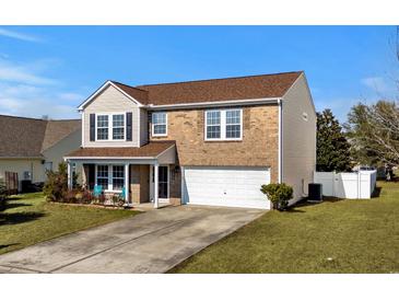 Charming two-story home featuring a brick facade, vinyl siding, and a two-car garage at 182 Tibton Circle, Myrtle Beach, SC 29588