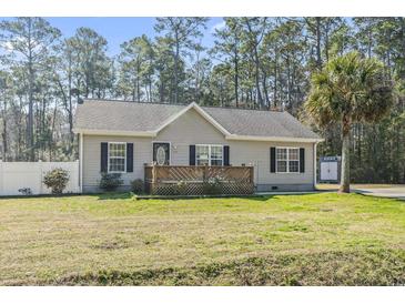 Charming single-story home with light siding, black shutters, and a wooden lattice front porch at 2192 Bell Rd., Longs, SC 29568