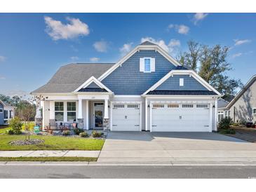 Beautiful two-story home featuring a three-car garage, a blue roof, and an inviting front yard at 3105 White Jasmine Dr., Little River, SC 29566