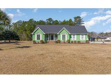 Charming green home with mature trees and well-manicured landscaping at 354 Deer Run Ave., Georgetown, SC 29440