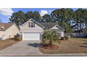 Charming single-story home featuring a two-car garage, well-maintained landscaping and beautiful lawn at 357 Cabo Loop, Myrtle Beach, SC 29588