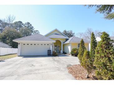 Charming single-story home featuring a two-car garage and well-maintained landscaping on a sunny day at 4244 Luck Ave., Little River, SC 29566