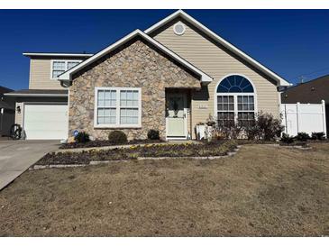 Charming home featuring stone accents, well-maintained landscaping, and a welcoming front entrance at 4305 Rivergate Ln., Little River, SC 29566