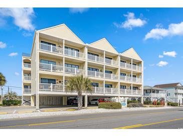 Inviting three-story condo with white balconies, covered parking, and a convenient beachside location at 4601 N Ocean Blvd. # 203, North Myrtle Beach, SC 29582