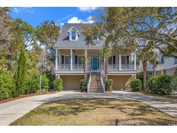 Charming coastal home with double garages, a basketball hoop, and inviting front porch at 534 South Creekside Dr., Murrells Inlet, SC 29576