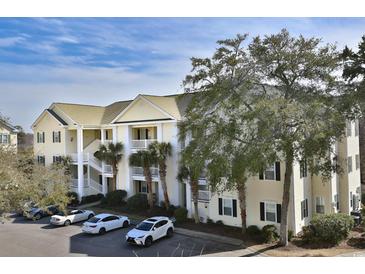 Inviting three-story condo with private patios, palm trees, and convenient parking at 601 Hillside Dr. N # 1731, North Myrtle Beach, SC 29582