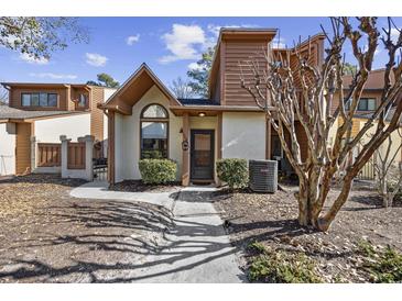 Charming condo featuring a brown and white exterior, landscaped front yard, and inviting entryway at 617 S 13Th Ave. # 116, Surfside Beach, SC 29575