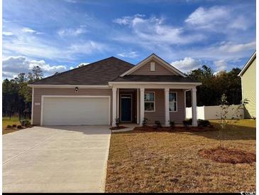 Charming single-story home with a two-car garage and well-maintained lawn on a sunny day at 1431 Porchfield Dr., Conway, SC 29526