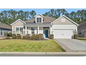 Charming single Gathering home with manicured lawn, blue front door, and neutral color palette at 145 Copper Leaf Dr., Myrtle Beach, SC 29588