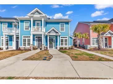 Charming two-story blue townhome with a quaint balcony and welcoming front entrance at 3534 Pampas Dr. # 505, Myrtle Beach, SC 29577