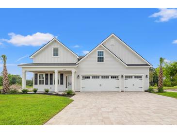 Charming white two-story home with three-car garage and patterned brick driveway at 368 Hayloft Circle, Conway, SC 29526