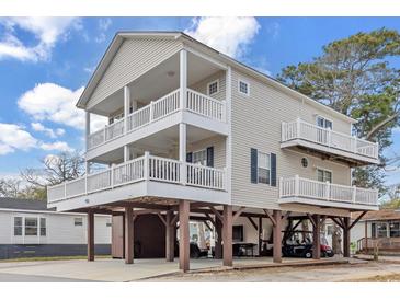 Exterior elevation of a charming raised beach house featuring spacious balconies and ground-level parking at 6001-N50 S Kings Hwy., Myrtle Beach, SC 29575