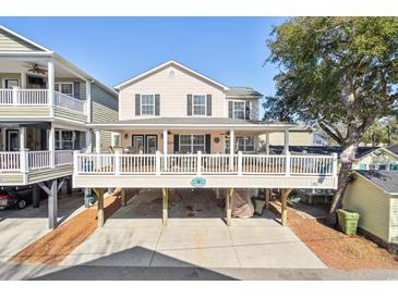 Charming coastal home featuring a spacious front porch and ample parking space underneath at 6001-Z-26 South Kings Hwy., Myrtle Beach, SC 29575