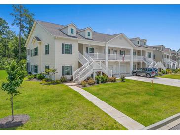 Charming townhome with double front porch, manicured lawn, and private garage in quiet neighborhood at 933 Jackline Place # 101, Murrells Inlet, SC 29576