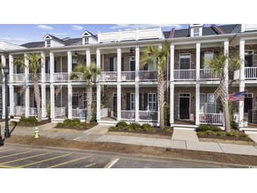 Charming townhomes feature brick facade, white columns, and private balconies with palm tree landscaping at 2794 Howard Ave. # D, Myrtle Beach, SC 29577