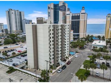 Condo building exterior featuring a pool, parking, and beach view in a coastal setting at 400 20Th Ave. N # 1101, Myrtle Beach, SC 29577