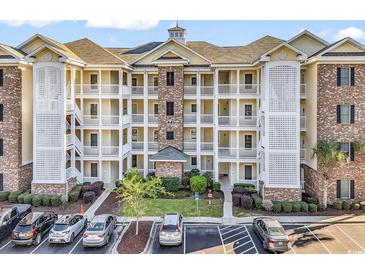 Charming condominium with a combination of light yellow and brown brick, complemented by a well-manicured lawn and convenient parking at 4861 Luster Leaf Circle # 204, Myrtle Beach, SC 29577