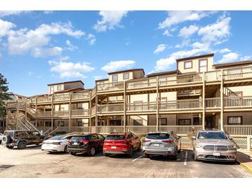 Exterior view of building featuring multiple stories, balconies, and convenient parking at 501 Maison Dr. # E20, Myrtle Beach, SC 29572